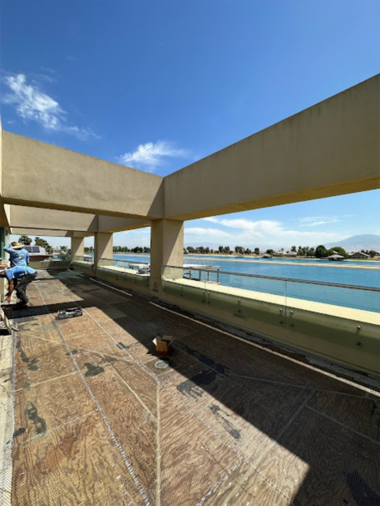Workers performing planter repair work on concrete floor